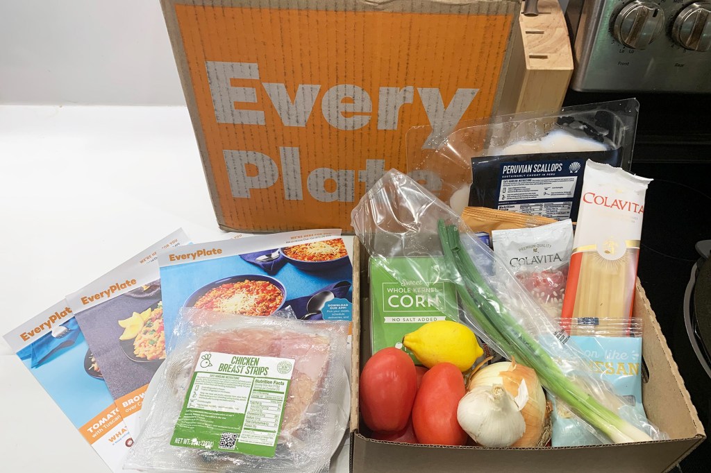 An EveryPlate food box with ingredients on a white counter